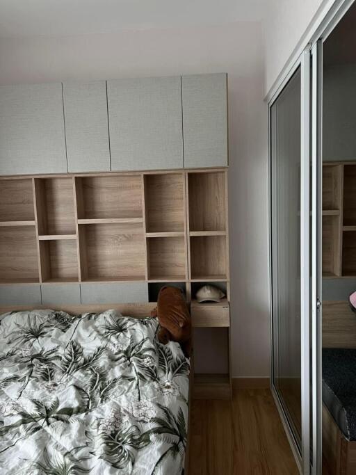 Cozy bedroom interior with built-in wardrobe and shelving units