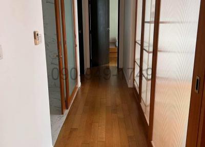 Spacious corridor with wooden flooring and natural light
