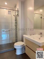 Modern bathroom with glass shower enclosure and white fixtures