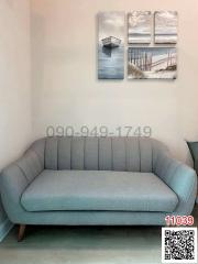 Cozy living room with a modern gray sofa and decorative wall art