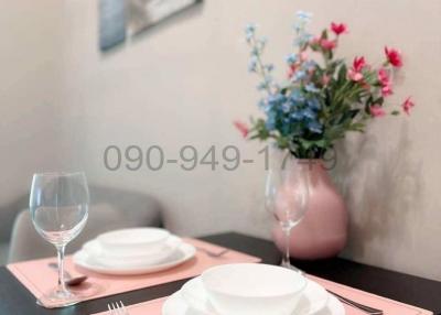 Elegant dining table setup with dinnerware and floral centerpiece
