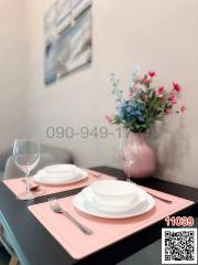 Elegant dining table setup with dinnerware and floral centerpiece