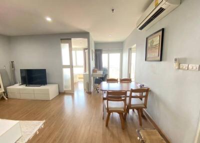 Bright and spacious living room with dining area and balcony access