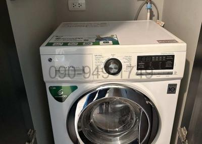 Modern LG washing machine in a small laundry area