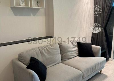 Modern living room with elegant sofa and decorative wall