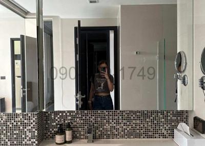 Modern bathroom interior with mosaic tile backsplash and elegant countertop basin