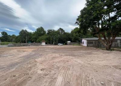 Spacious empty lot with natural surroundings and overcast sky