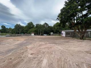 Spacious empty lot with natural surroundings and overcast sky