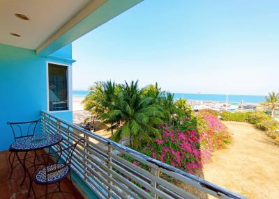 Balcony with ocean view, seating area and tropical foliage