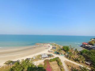 Scenic ocean view from a property showcasing the beach, boats, and clear skies