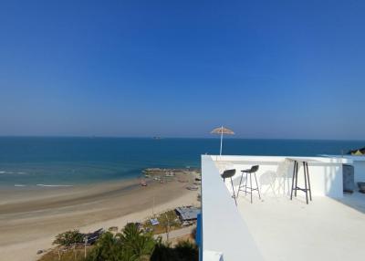 Panoramic sea view from a spacious balcony with seating