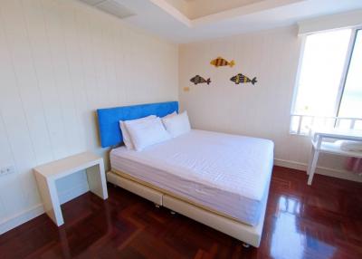 Bright and cozy bedroom with wooden flooring and minimalistic decor