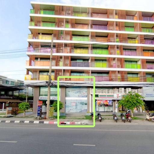 Colorful urban apartment building facade with commercial space on the ground floor