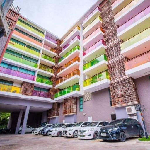 Colorful apartment building exterior with a parking lot