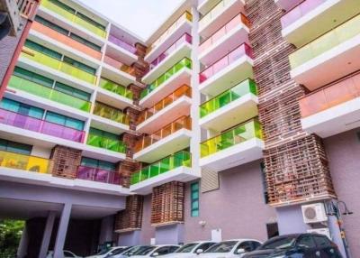 Colorful apartment building exterior with a parking lot