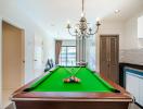 Spacious game room with pool table, modern chandelier, and open layout