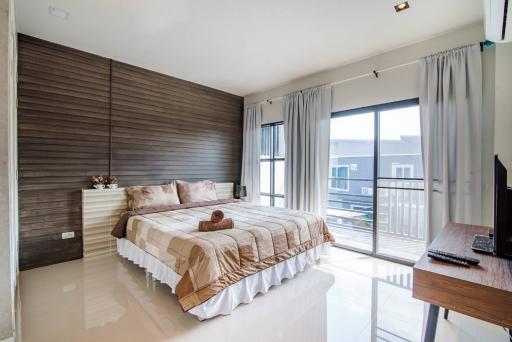 Spacious bedroom with queen-sized bed and modern decor