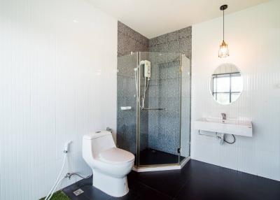 Modern bathroom with shower, toilet, and sink