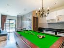 Spacious recreational area with pool table, modern kitchen, and comfortable living space
