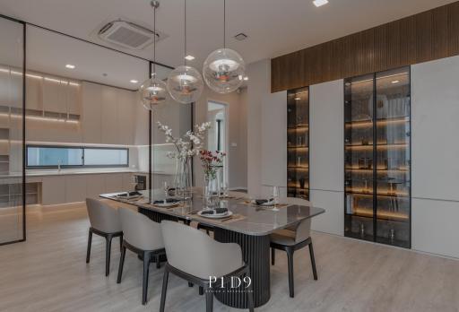 Modern dining room with open-plan kitchen and wine cellar
