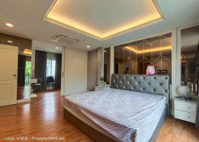 Spacious master bedroom with modern design and ample lighting
