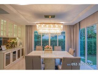 Elegant dining room with chandelier and garden view