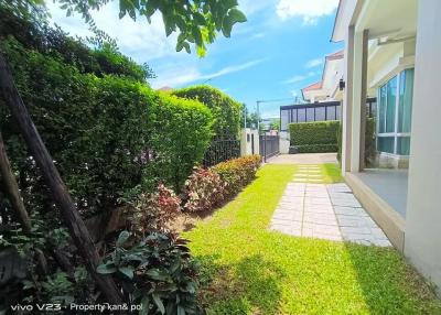 Spacious well-maintained garden with a pathway in a residential property