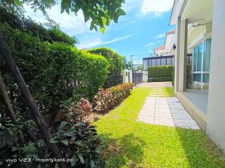 Spacious well-maintained garden with a pathway in a residential property