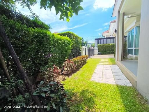 Spacious well-maintained garden with a pathway in a residential property