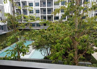 View of a residential complex with pool and landscaping from a balcony