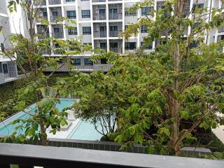 View of a residential complex with pool and landscaping from a balcony