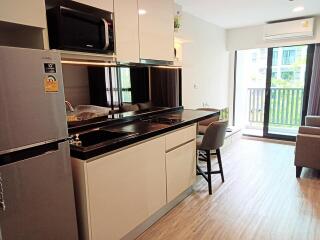 Modern kitchen with stainless steel appliances and open layout to living area