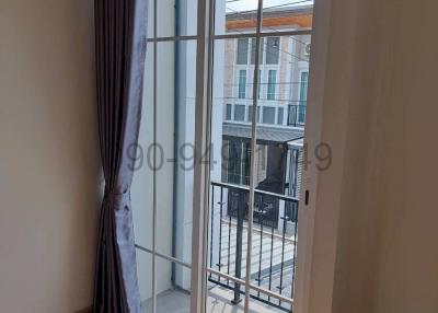 Bright bedroom with large window and balcony access