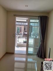 Spacious living room with sliding door leading to a balcony