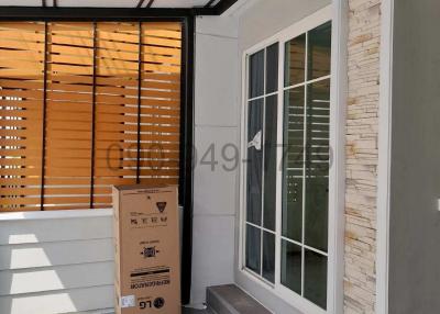 Modern home patio with tiled flooring and large glass door