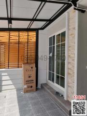 Modern home patio with tiled flooring and large glass door