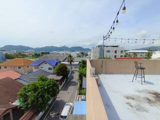 Rooftop terrace with a view of the surrounding neighborhood and mountains in the distance
