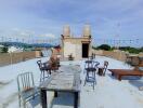 Spacious rooftop terrace with outdoor furniture and scenic view