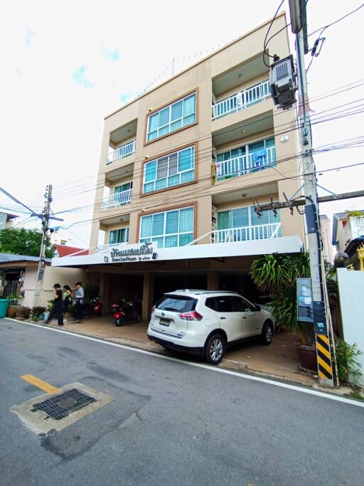 Modern multi-storey residential building with vehicle parking