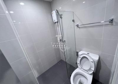 Modern bathroom with wall-mounted toilet and shower