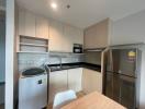 Compact modern kitchen with stainless steel appliances