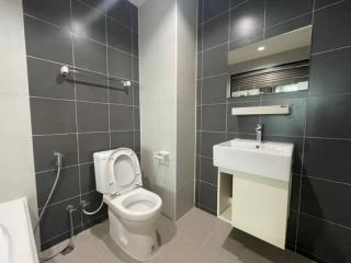 Modern bathroom with dark tiles and white fixtures