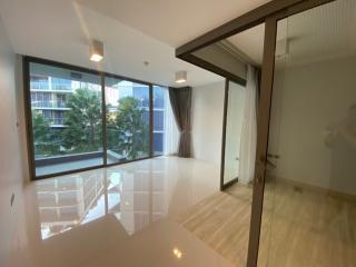 Spacious and well-lit living room with large windows and glossy tiled floor