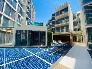 Modern residential building with pool and lounge area