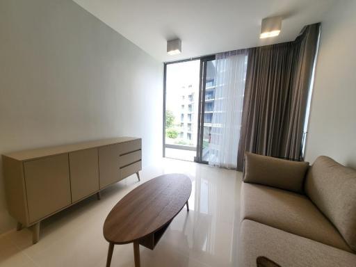 Spacious and well-lit living room with modern furniture and large window