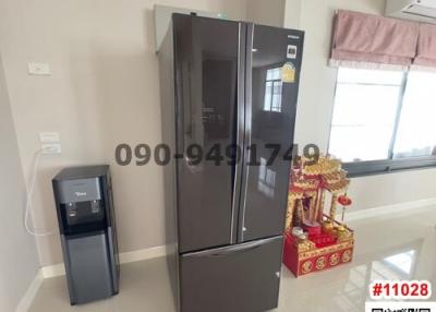 Modern kitchen with large refrigerator and water dispenser