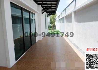 Spacious patio area with large sliding glass doors and tiled flooring