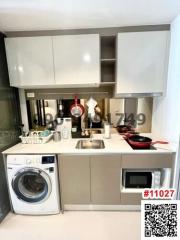 Modern compact kitchen with appliances and white cabinetry