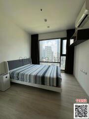 Modern bedroom with large window and city view