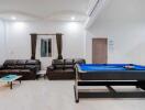 Spacious living room with pool table and modern furniture